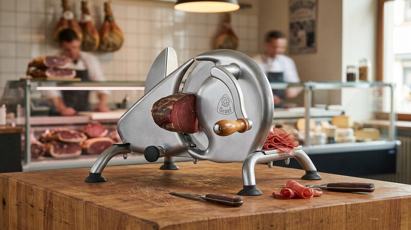 GRAEF H9 slicer cutting cured meat on a wooden counter in a butcher shop